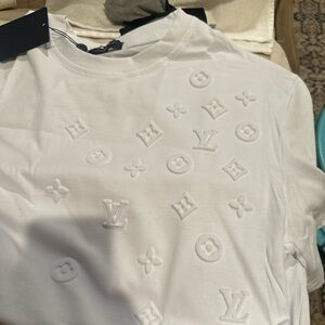 L V White Logo Embossed Tee 
Very good quality